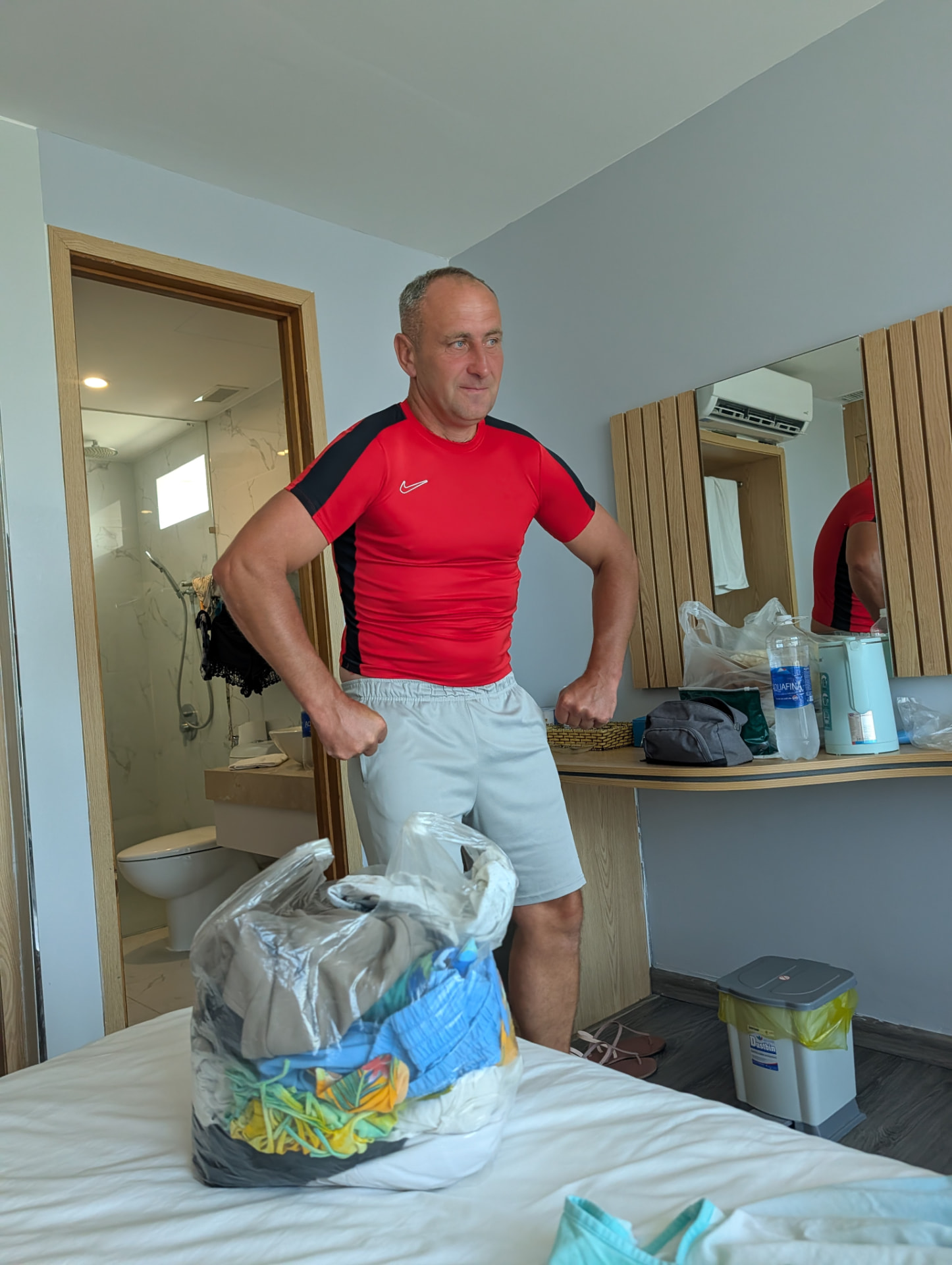 Portrait of the founder flexing in a hotel room